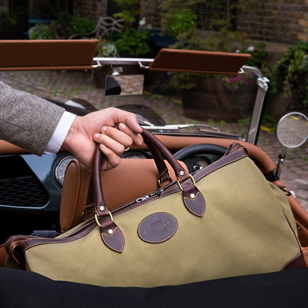 Cotswold Weekend Bag by Ettinger in Olive/Havana pictured in the back of an old vintage car